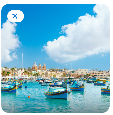 Colourful traditional fishing boats moored in a sunny Mediterranean harbour